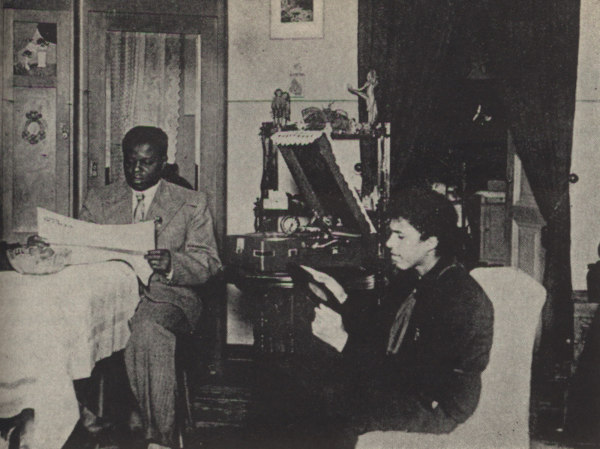 Bashir Shambe at home with his wife and son.