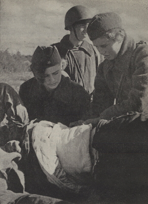Red Cross nurses Vera Sarayeva and Tanya Golubenkova attending to a wounded Red Army man at the front.